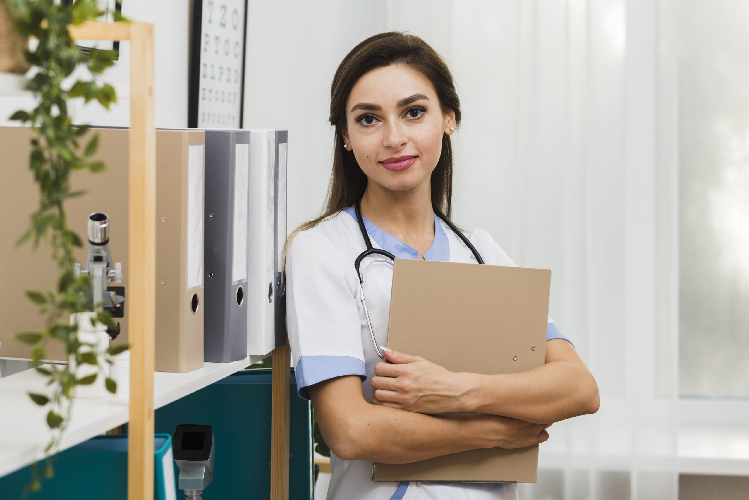 Confident healthcare professional holding a file in a medical office environment, representing hospital administration.